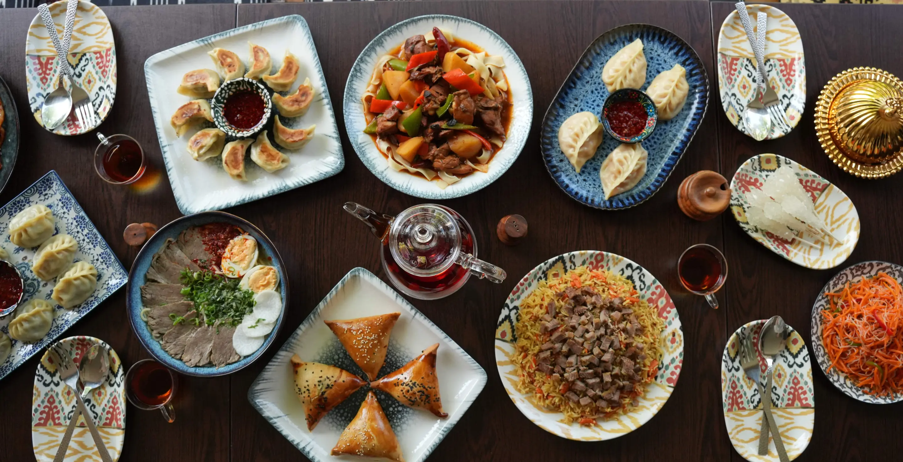 Gulja Uyghur hero — food framed by the cultural palette